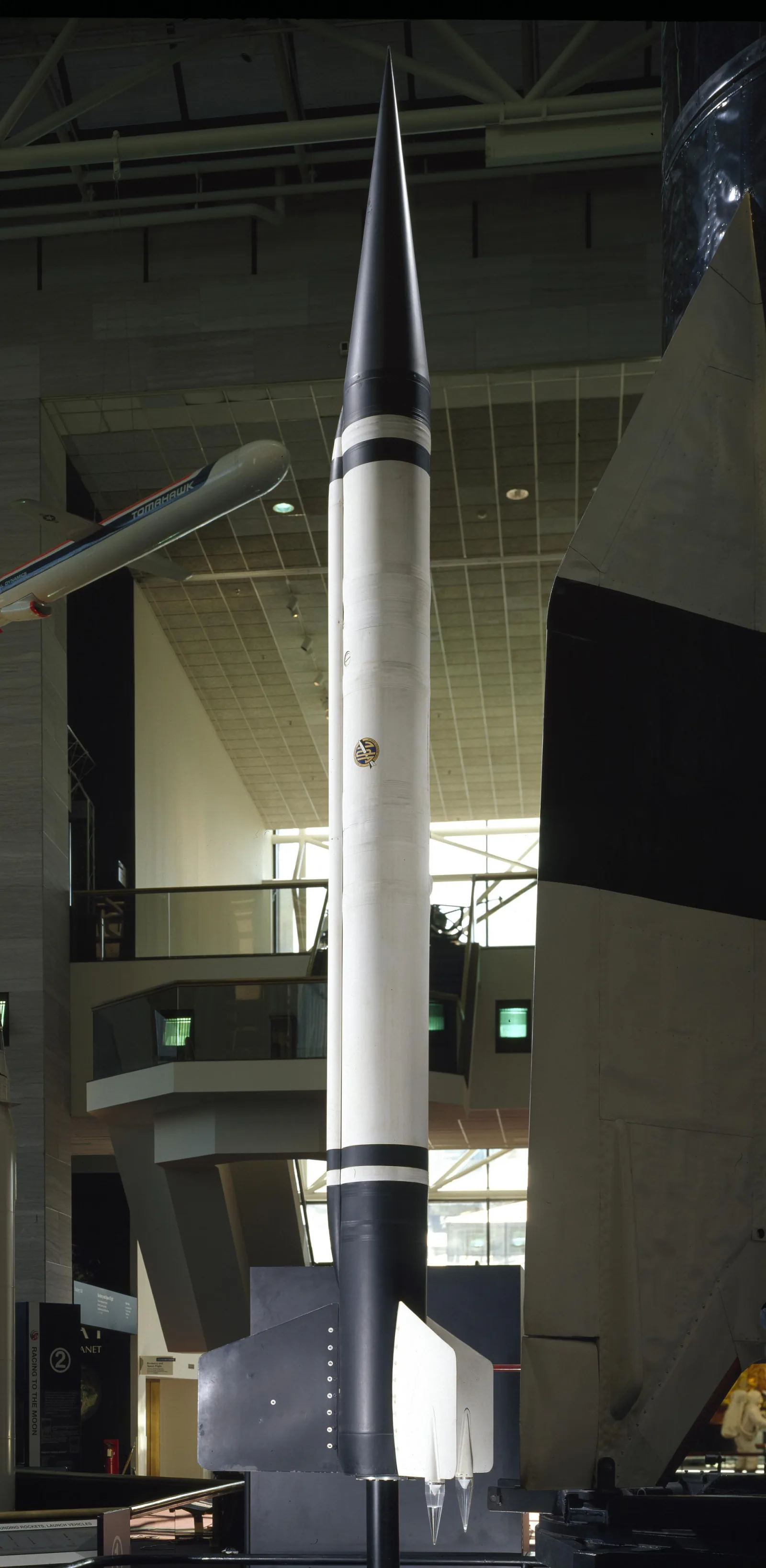 A tall WAC Corporal liquid-fuel sounding rocket is shown as a complete artifact.