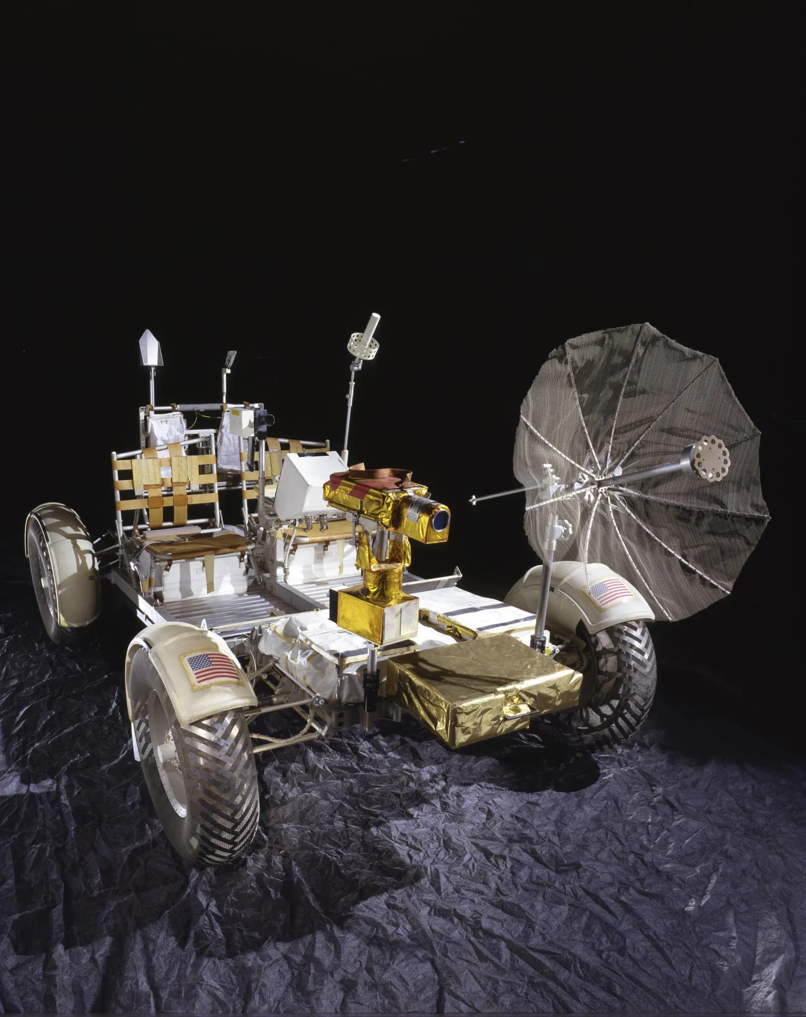 A lunar roving vehicle qualification unit is displayed with its wire-mesh wheels.