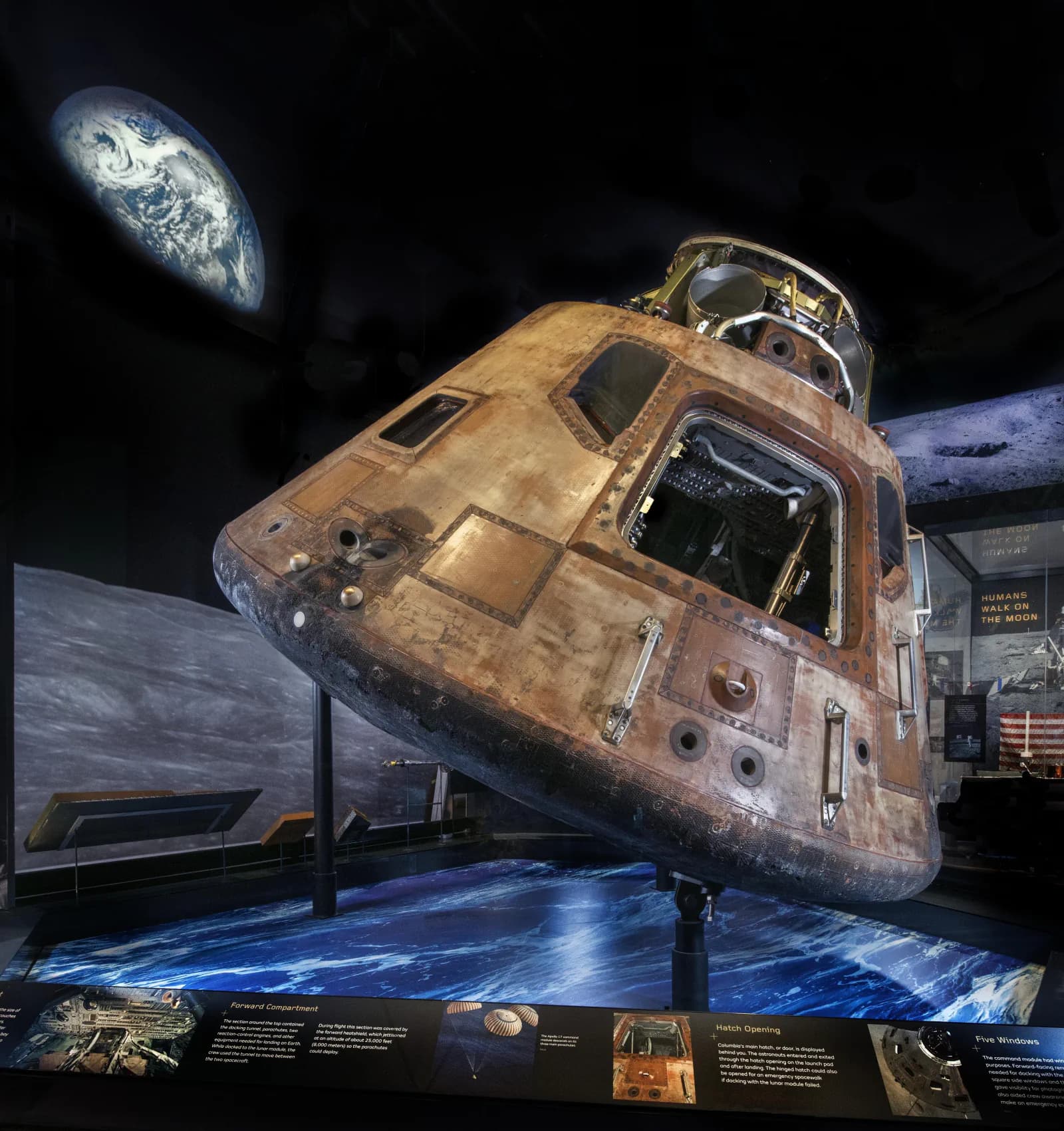 The Apollo 11 command module is displayed with its conical heat shield and hatch.